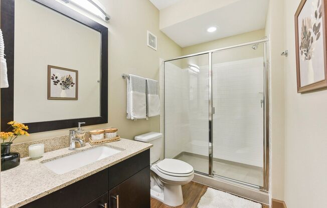 a bathroom with a shower toilet sink and mirror at Lakeline East Apartments, Cedar Park, 78613
