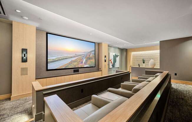 Private theater room with oversized screen, plush leather seating, and intimate lighting for movie nights