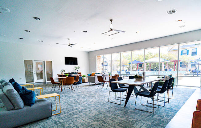 a large living room with a table and chairs