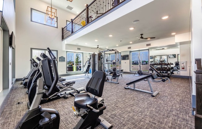 A spacious home gym with a variety of exercise equipment.