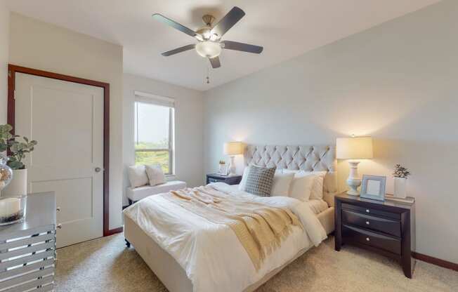 a bedroom with a large bed and a ceiling fan