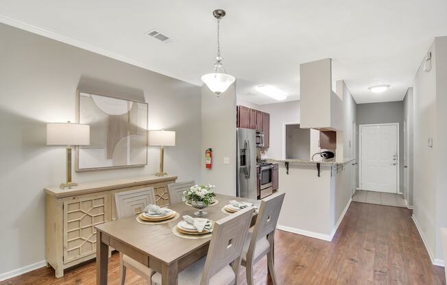 a kitchen and dining room with a table and chairs