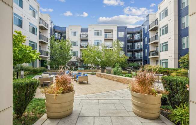 an outdoor patio with potted plants at the bradley braddock road station apartments