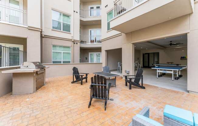 Patio with a ping pong table and chairs at Residences at 3000 Bardin Road, Grand Prairie