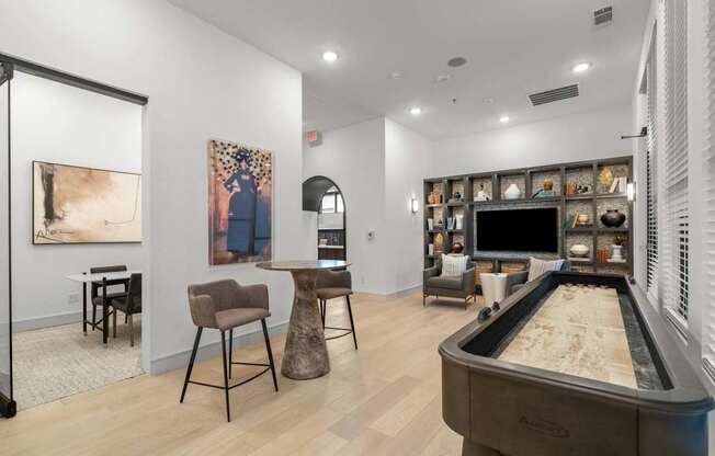 a living room with a pool table and a television