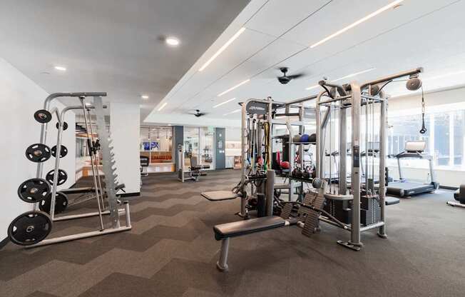 A well-equipped gym with a variety of machines and weightlifting equipment.