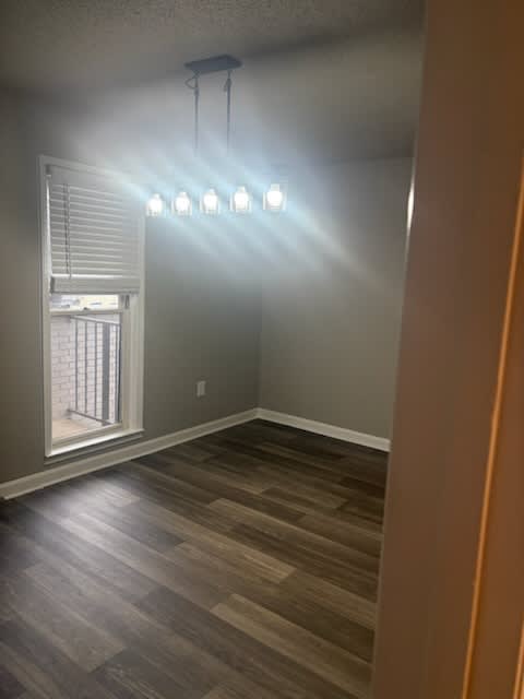 A room with a window and a light fixture.