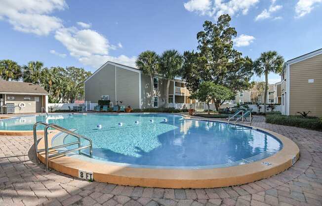 a swimming pool with apartments in the background