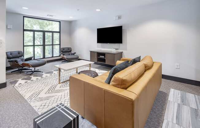 a living room with a couch and a television at The Hendrix, Atlanta, GA