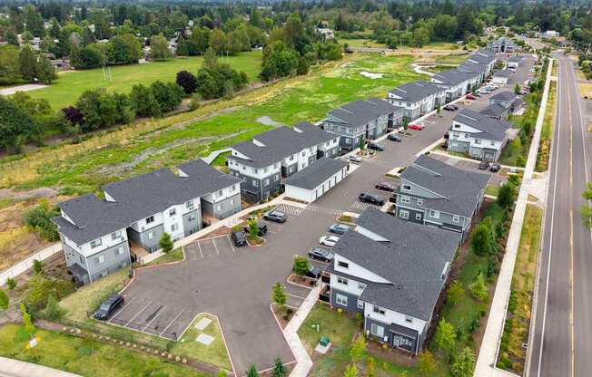 A large residential complex with multiple houses and a parking lot.