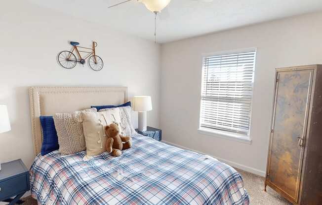 a bedroom with a bed and a bike on the wall