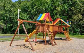 a playground with a swing set and a slide