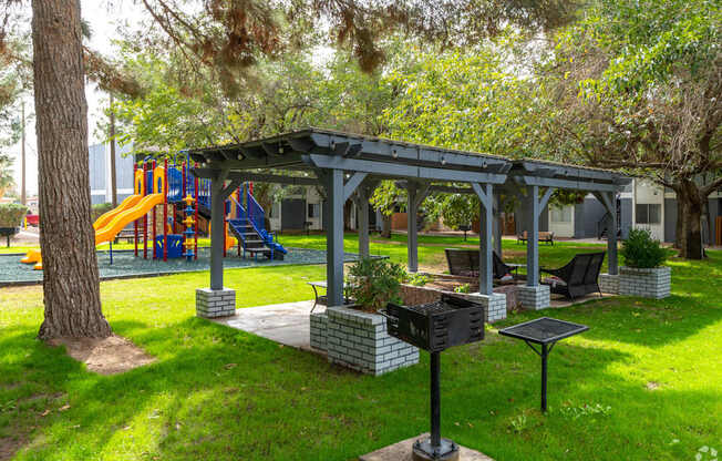 A playground with a slide and a gazebo.