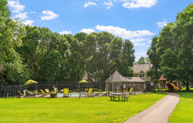 A playground with a slide and a swing set.