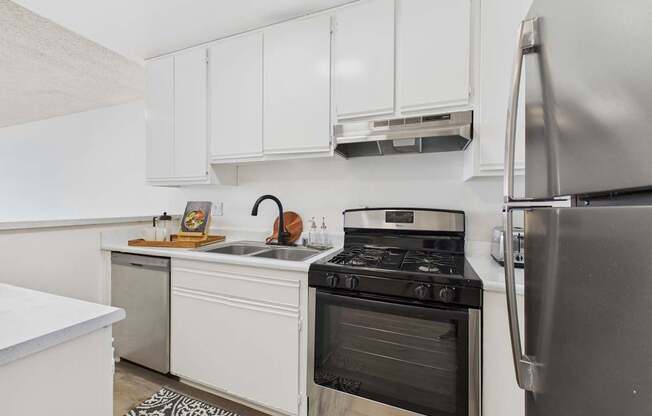 A kitchen with a stove, oven, and refrigerator.
