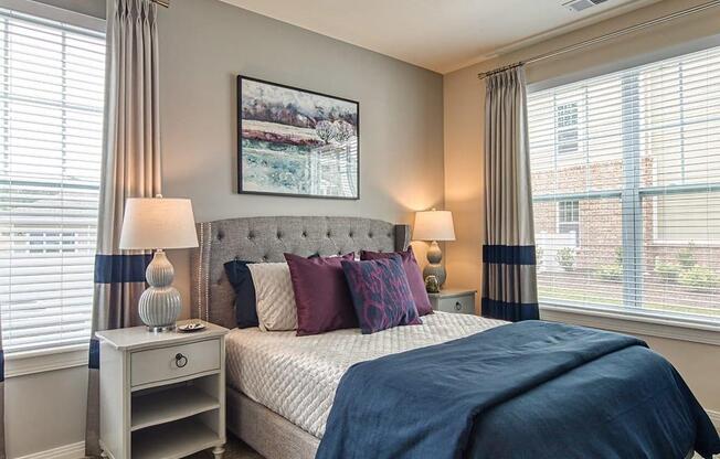 a bedroom with a bed and two windows  at Sapphire at Centerpointe, Midlothian