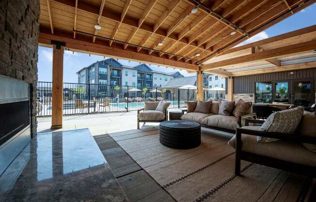 A wooden patio with a couch and a table.