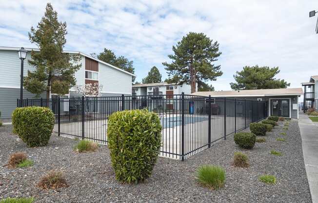 A swimming pool that's surrounded by a black wrought iron fence at Wildflower, Washington