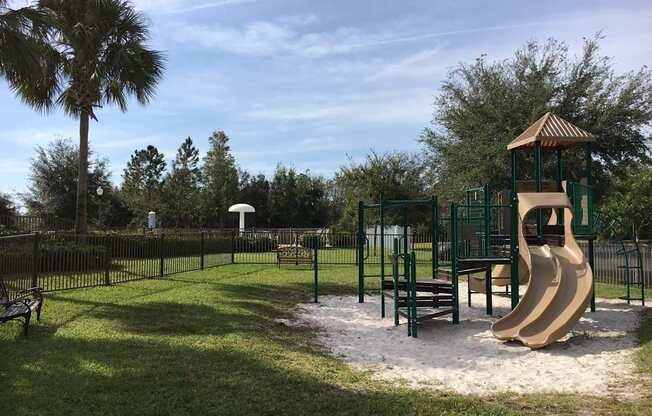A playground with a slide and a wooden structure.