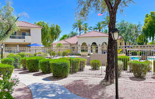 A residential area with a house, trees, and a pool.