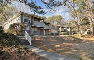 A house with a grey roof and white fence.