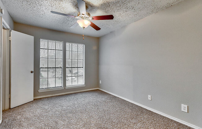 an empty living room with a ceiling fan and window at The Broadwater at Salado Creek, Texas