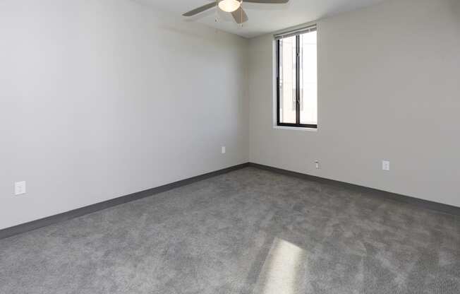 Spacious living room with neutral walls and ample natural light.