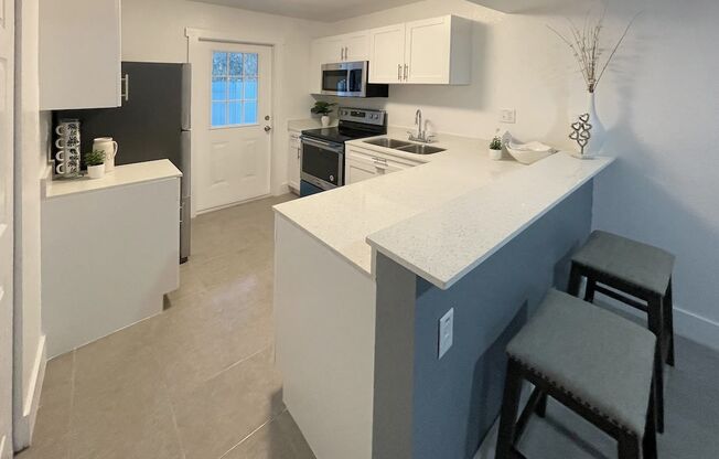 a kitchen with a counter top and a sink