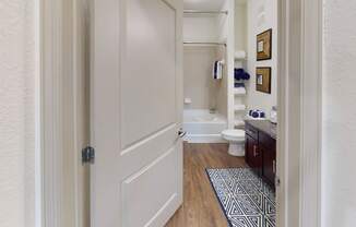 a bathroom with a white toilet next to a bathtub