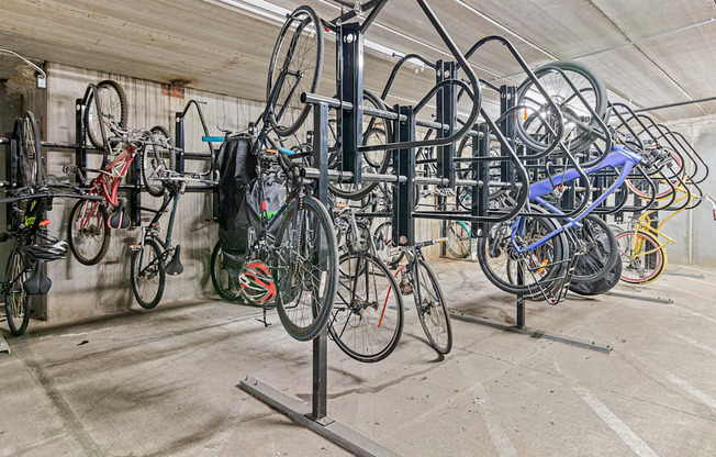 a row of bikes hanging on a rack in a building
