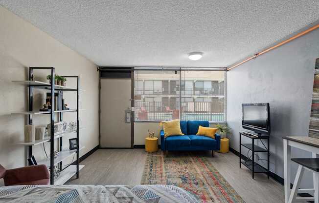 A living room with a blue couch and a television.