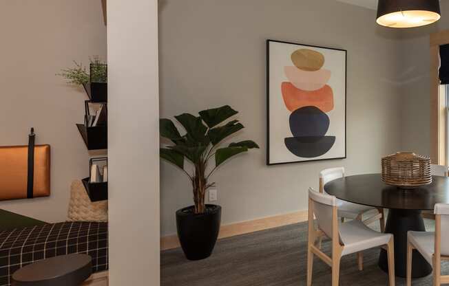 a room with a table and chairs and a painting on the wall at The Bend Arbordale, Virginia