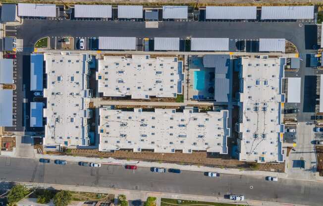 a bird's eye view of a building complex with blue and white roofs at Loma Villas Apartments, California