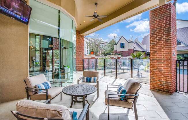 Outdoor lounge seating and grilling area at pool
