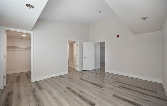 a renovated living room with white walls and wood floors at Track 281 Apartments, Sacramento, 95811