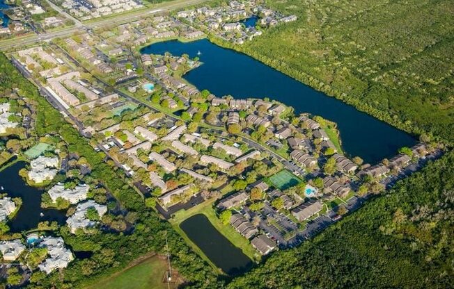 This aerial shot shows our gated community, alongside the 15 acre lake, which includes three pools, and sports courts.