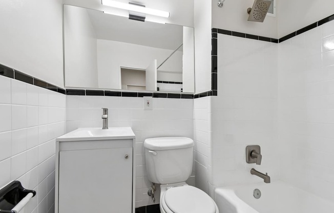 A white toilet sits next to a sink in a bathroom.