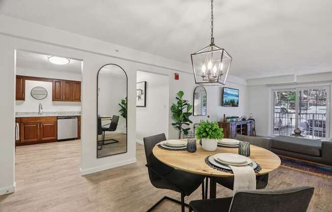 A modern dining room with a round table and chairs.