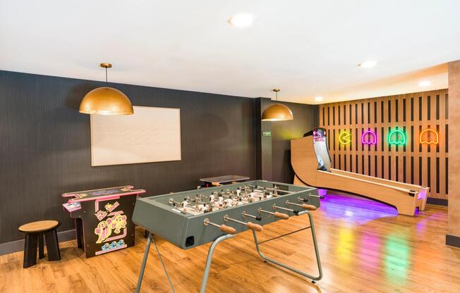 A vibrant game lounge at Modera Higley Commons, blending retro-inspired details and inviting spaces designed for relaxed competition and connection.