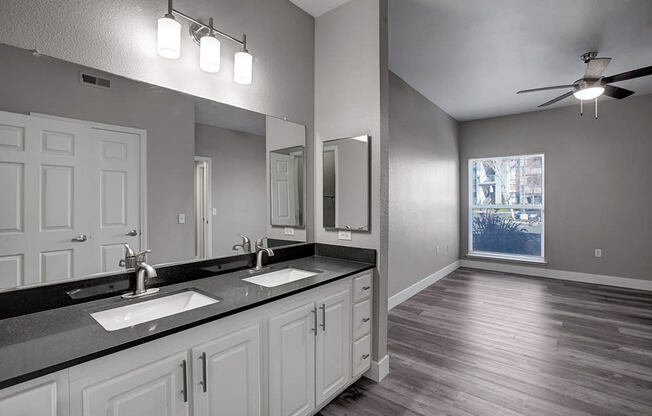 a bathroom with a large mirror and a window
