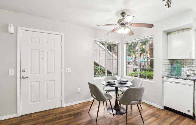 A dining room with a table and chairs.
