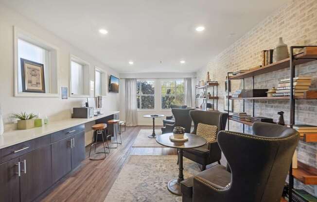 A modern kitchen with dark wood cabinets and a brick wall.