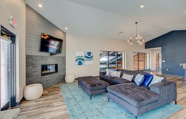 a large living room with a large couch and a large tv on the wall