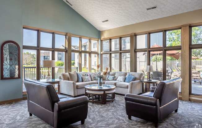 A living room with a large window and a view of a backyard.