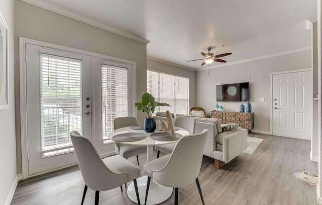 A dining room with a table and chairs.