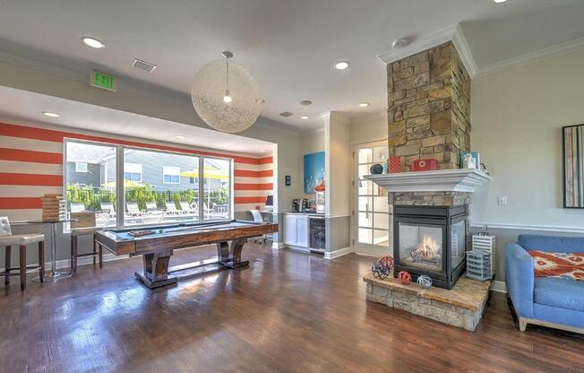 a game room with a pool table and a fireplace
