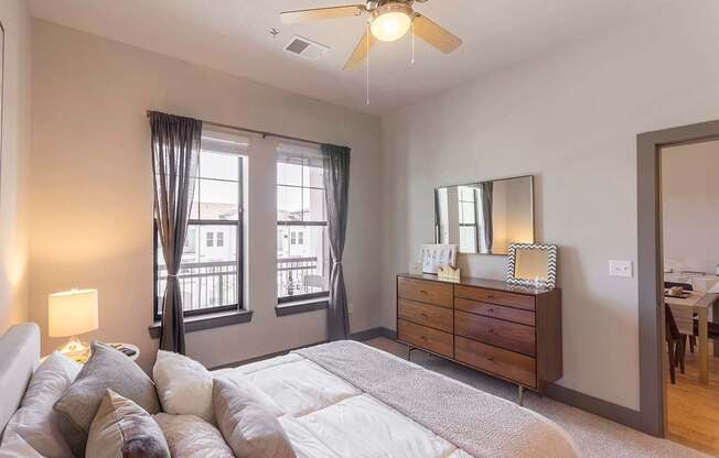 a bedroom with a large bed and a ceiling fan