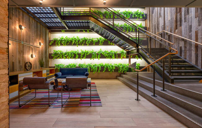 a living wall in a lobby with couches and stairs