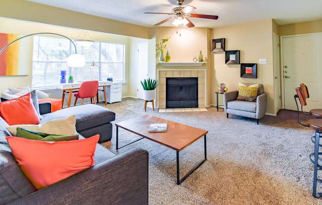 a living room with a fireplace and a ceiling fan  at Riverset Apartments, Tennessee
