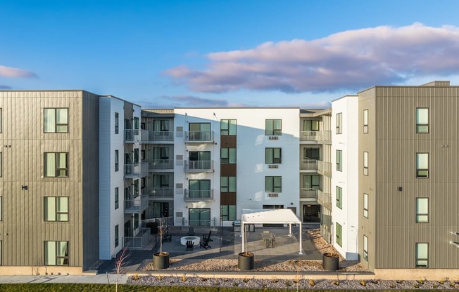 an image of an apartment building with a blue sky in the background